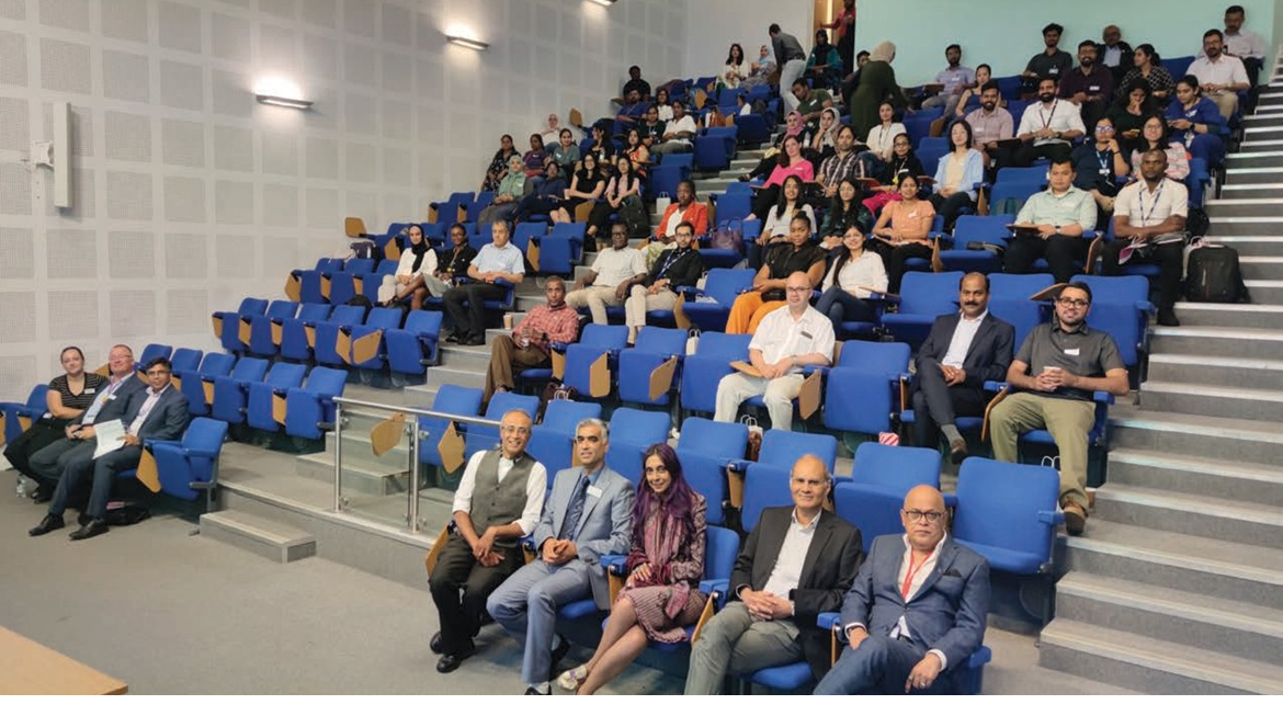 Attendees seated in a lecture hall at the SAS conference, with participants attentively listening or waiting for a presentation.