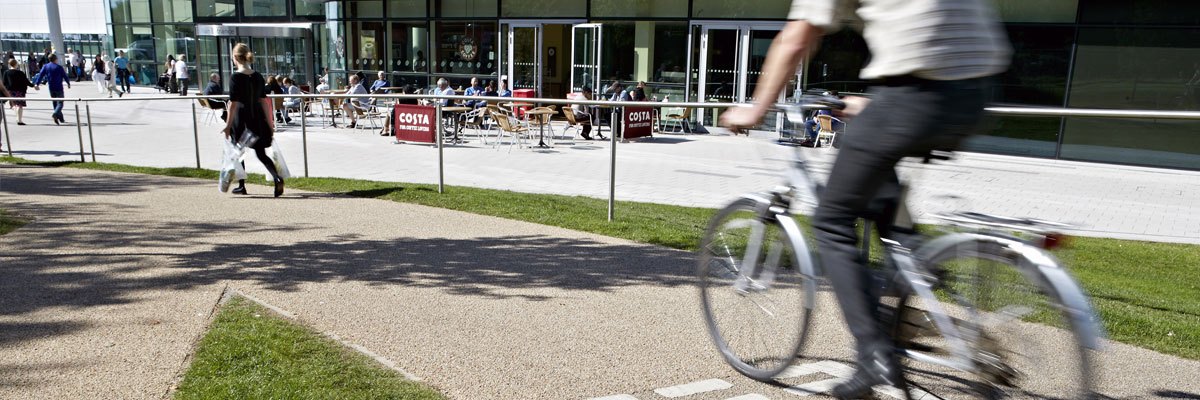 Member of staff on the cycle path outside QEHB